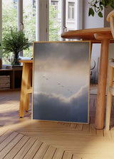 Cuadro minimalista de aves volando entre las nubes al amanecer, evocando calma y libertad. Disponible en kudeko.com.