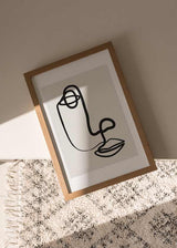 decoración con cuadros, ideas - Cuadro de rostro abstracto en blanco y negro con fondo ligeramente beige.