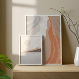 Gerahmtes Wandbild mit Küsten- oder Seelandschaft, sanften Bergen, beiger Kugel, hellgrauem Wasser, Sand-, Altrosa- und Taupetönen im minimalistischen Stil. Erhältlich auf kudeko.com