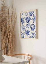 Cuadro de conchas marinas y hojas tropicales en tonos azul cobalto y azul suave sobre fondo blanco, de estilo ilustración. Disponible en kudeko.com