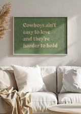 Cuadro con frase "Cowboys ain't easy to love and they're harder to hold" sobre fondo verde, kudeko.com