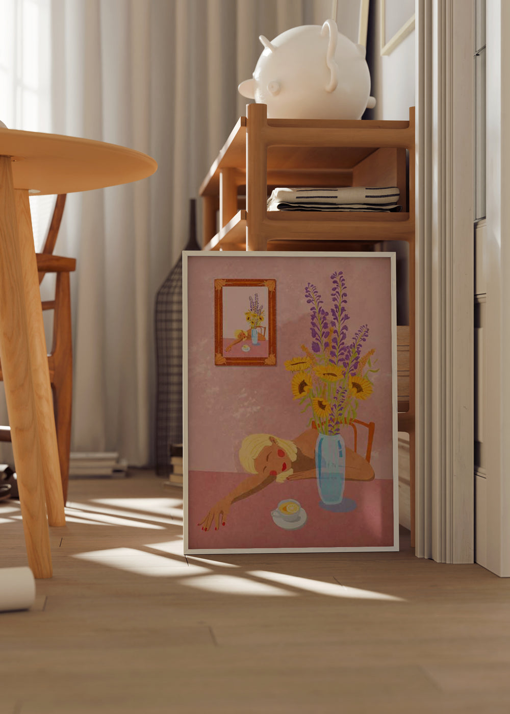 Quadro emoldurado com mulher deitada sobre uma mesa, jarra azul, girassóis amarelos, flores violetas, fundo rosa suave e estilo de ilustração delicado. Disponível em kudeko.com