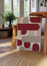 Quadro geométrico com formas semicirculares em tons de bordô e bege, estilo decorativo moderno e equilibrado para interiores. Disponível em kudeko.com