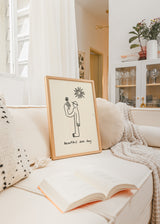 Cuadro decorativo de estilo minimalista y blanco_y_negro colocado en salón, figura minimalista con flor bajo el sol, modelo Beautiful Sun Day