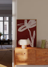 Tableau floral minimaliste avec fleur blanche sur fond bordeaux, style décoratif épuré et contraste élégant. Disponible sur kudeko.com