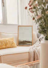 Quadro com composição abstrata em tons de creme, bege, branco sujo e castanho terra, horizonte difuso, textura visual suave e estilo minimalista contemporâneo. Disponível em kudeko.com