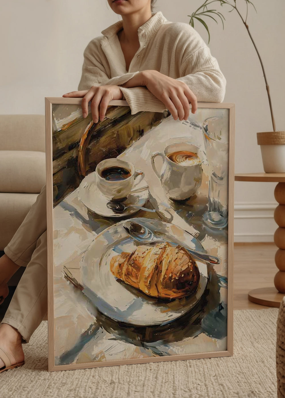 Quadro minimalista que captura um instante de tranquilidade com café e um croissant. Disponível em kudeko.com.