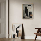 Tableau encadré avec composition abstraite de formes noires courbes, lignes fines, fond beige, écru et nuances terre, dans un style contemporain épuré. Disponible sur kudeko.com