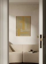 Tableau encadré à composition abstraite avec blocs rectangulaires superposés, texture visuelle textile, tons beige, sable, crème et moutarde, style abstrait et géométrique. Disponible sur kudeko.com