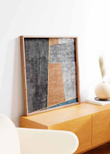 Tableau carré avec composition abstraite de formes géométriques en noir, gris, blanc cassé, ocre brun et bleu pétrole, dans un style contemporain épuré. Disponible sur kudeko.com