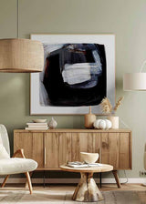 Tableau carré à composition abstraite avec blocs noirs, traces blanches, nuances grises et légers accents brun rouille, dans un style contemporain épuré. Disponible sur kudeko.com