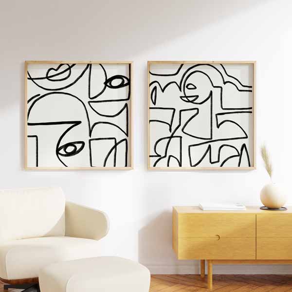 Ensemble de deux tableaux avec visages abstraits en lignes noires continues sur fond blanc, composition monochrome au style minimaliste et contemporain pour décoration murale. Disponible sur kudeko.com