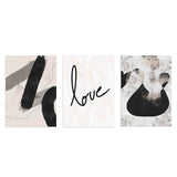 Conjunto de tres cuadros con formas abstractas negras y grises, palabra love en negro y fondo beige suave, de estilo abstracto. Disponible en kudeko.com