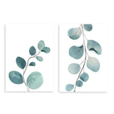 Ensemble de deux tableaux avec fines branches botaniques, feuilles arrondies bleu vert, aigue-marine et vert doux, dans un style floral épuré sur fond blanc. Disponible sur kudeko.com