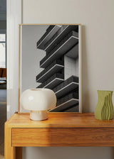 Wandbild eines zeitgenössischen Gebäudes mit gestaffelten Balkonen, klaren Linien, Fassade in Grau Weiß und Schwarz, architektonische Komposition im modernen urbanen Stil. Erhältlich auf kudeko.com