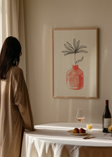 Tableau encadré avec vase corail rosé, fleur au trait noir, fond blanc, composition légère, élégante et style minimaliste apaisant. Disponible sur kudeko.com