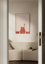 Gerahmtes Wandbild mit drei Gläsern voller rosafarbener Flüssigkeit, beigem Hintergrund, kleiner weiblicher Figur, cremefarbenen und terrakottafarbenen Tönen, surrealem minimalistischem Stil. Erhältlich auf kudeko.com