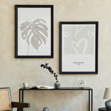 Gerahmtes Wandbild mit mehreren weißen Herzen in freier Linienführung auf hellbeigem Hintergrund, klare Komposition, sanfte Farben und minimalistischer Stil mit ruhiger romantischer Note. Erhältlich auf kudeko.com