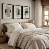 Wandbild mit abstrakter Komposition aus überlagerten Formen in Salbeigrün, hellem Beige, Schwarz und Graubraun auf weißem Hintergrund, in einem klaren zeitgenössischen Stil. Erhältlich auf kudeko.com