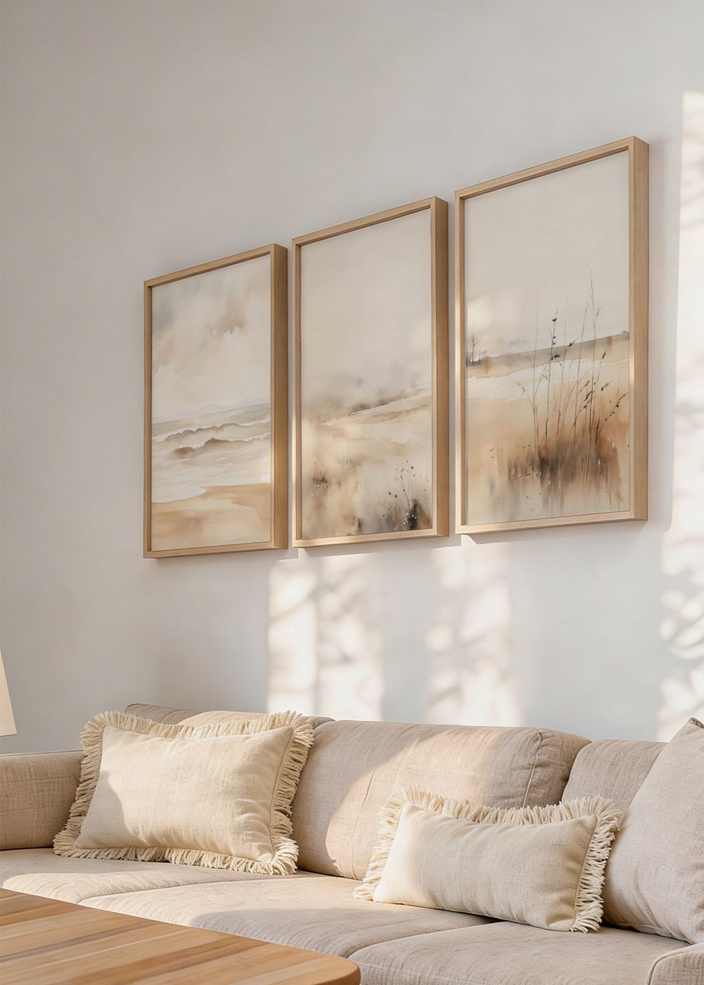 Conjunto de três quadros com praia de areia, mar calmo, névoa suave, juncos costeiros e tons de bege, branco partido e cinzento claro, em estilo natureza e paisagem. Disponível em kudeko.com