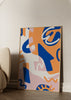 Tableau encadré avec formes abstraites organiques et géométriques en bleu, orange, rose poudré et blanc cassé, dans un style abstrait contemporain avec courbes et éléments graphiques. Disponible sur kudeko.com