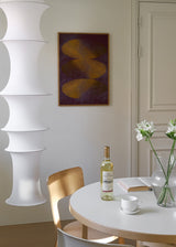 Wandbild abstrakt mit goldenen ovalen Formen auf granatfarbenem Hintergrund, in schwarzem Rahmen, eleganter dekorativer Stil. Erhältlich auf kudeko.com