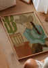 Tableau décoratif de style minimaliste avec illustration dans un salon, cowgirl du désert avec cactus dans des tons chauds, modèle Desert Cowgirl and Cactus. Disponible sur kudeko.com