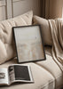 Quadro costeiro minimalista em tons de bege, branco pérola e areia, com figura solitária a caminhar junto à água e estilo abstrato depurado. Disponível em kudeko.com