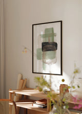 Wandbild mit abstrakter Komposition aus überlagerten Formen in Salbeigrün, hellem Beige, Schwarz und Graubraun auf weißem Hintergrund, in einem klaren zeitgenössischen Stil. Erhältlich auf kudeko.com