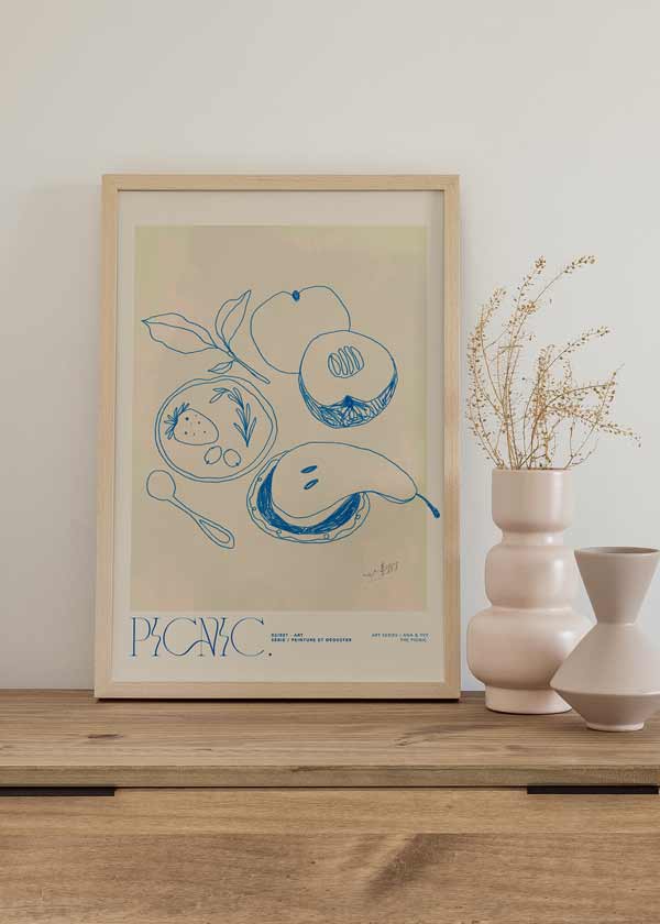 Cuadro de ilustración artística con frutas en trazo azul y fondo beige, ideal para cocina.