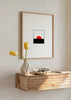Gerahmtes Wandbild mit roter halbkreisförmiger Sonne, schwarzem Horizont, weißem Hintergrund, klaren Linien und markantem Rot Schwarz Weiß im minimalistischen Stil. Erhältlich auf kudeko.com