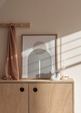 Wandbild mit geometrischem Regenbogen aus feinen schwarzen Linien, beigem Kreis, weißem Hintergrund und ruhigem minimalistischem Stil. Erhältlich auf kudeko.com