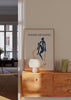 Gerahmtes Wandbild mit abstrakter menschlicher Figur in Marineblau, beigem Hintergrund, organischen senfgelben Formen und schwarzer Typografie im minimalistischen Stil. Erhältlich auf kudeko.com