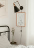 Cuadro decorativo de estilo minimalista y blanco_y_negro colocado en dormitorio, ilustración minimalista de manos entrelazadas, modelo Manos Amorosas