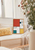 Quadro com composição geométrica de retângulos em vermelho coral, branco, azul petróleo e amarelo mostarda, destacados por linhas pretas marcantes, num estilo moderno e estruturado. Disponível em kudeko.com