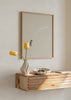 Gerahmtes Wandbild mit menschlicher Figur, Mondphasen in Beige, Weiß und Grau auf hellem Hintergrund, minimalistische und surrealistische Komposition. Erhältlich auf kudeko.com