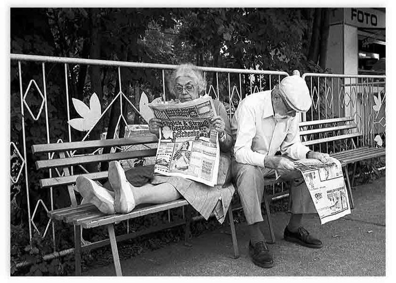 lámina decorativa fotográfica en blanco y negro de dos ancianos leyendo el periódico en un banco - kudeko